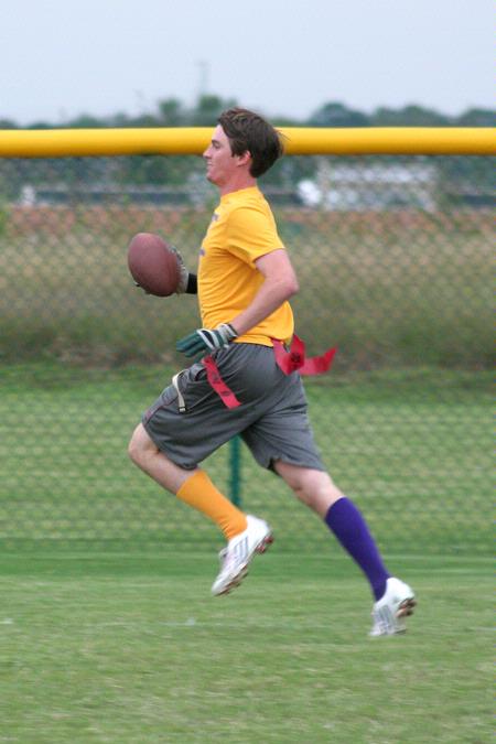 Roger Bolick, senior political science major, runs the ball down the field to score a touchdown for the SAE flag football team.