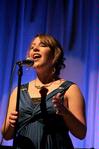 Libby Ford, senior accounting major, sings a filler act during All Sing 2009. - Photo by Kristi McMurry