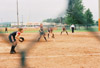 The Union infield, made up of Jessica Kee at third, Amy Mejia at shortstop (not pictured), Crystal Surgalski at second, and Christina Johnson at first are ready as College Station, Texas native Leah Gronberg delivers a pitch during the 2003 NAIA Softball World Series in Decatur, Ala. - Photo by Steven Aldridge