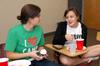 Rachel Donaldson, junior ESL major, catches up with one of her Life Group members, Amanda Browning, freshman youth ministry major, during one of their weekly Life Group meetings. - Photo by Kristi McMurry