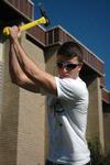 Jordan Russell, senior business major, removes a stump at the Hartland Place apartments during Campus and Community Day. - Photo by Beth Spain