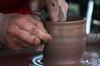 Paige Ward, senior art major, creates pottery during Arts in the Park for Homecoming 2009. - Photo by Megan Bailey