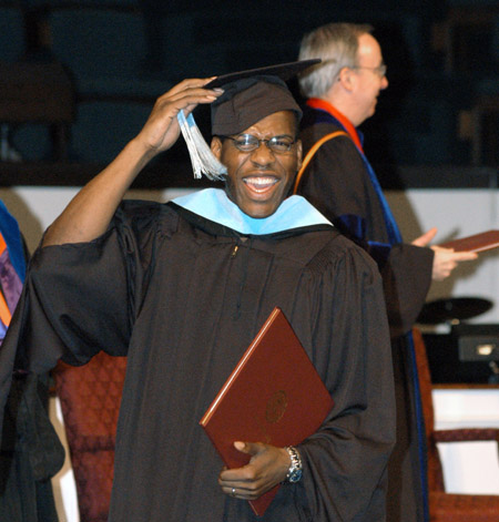 After receiving his Master of Education degree at the August 2003 commencement exercises, Joshua Duncan celebrates by ceremonially moving his tassle.