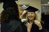 Laura Byrd helps fellow nursing graduate Krystal Watkins adjust her cap before the fall graduation ceremony. - Photo by Sarah Palmer