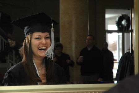 Tara Daniel, family studies graduate, takes a final look in the mirror before fall graduation ceremonies begin at West Jackson Baptist Church.