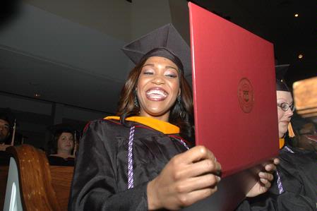 Shawanda Motlow, MSN graduate, shows her diploma during fall graduation.