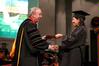 Jan Dui Kim receives her bachelor of science in chemistry from President Dockery at the fall graduation ceremony. Kim also received the Academic Excellence Medal for a major in chemistry. - Photo by Kristi McMurry