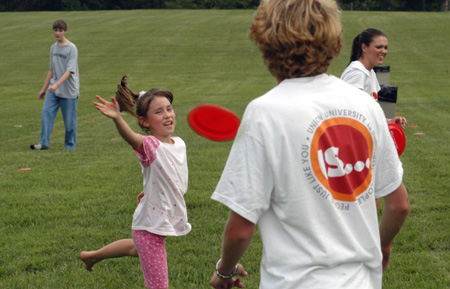 Sophomore Brad Spencer plays frisbee with a youngster at a Steven Curtis Chapman Brown Bag concert sponsored by Union in Franklin, Tenn. 