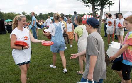 Sophomore Kathleen Lokey hands out Union frisbees at a Steven Curtis Chapman Brown Bag concert sponsored by Union in Franklin, Tenn. 