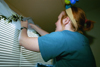 Alice Calvary decorates as she moves into her new dorm room during at the beginning of the Fall 2002 semester. - Photo by Justin Veneman