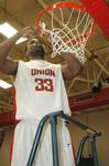 Freshman Samuel Danache cuts the net after winning the TranSouth Tournament in a game against Freed Hardeman University. - Photo by Jordan Buie
