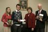 Phi Alpha Theta President Noah Arnold presents a Best Chapter Award check for $250 to Union’s Library Director Anna Beth Morgan while Chapter Vice President Katelyn O’Roark and Society Faculty Advisor Dr. Stephen Carls hold some of the new history books that the prize money paid for.  - Photo by Lauren Laster