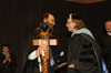 Lee Benson passes the university mace to Ann Singleton after she was named Faculty of the Year at Awards Day. - Photo by Jim Veneman