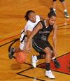 Ashley Lillard, junior psychology major, battles for the ball in the Second Round game of the NAIA National Tournament against Southern Polytechnic State University. The Lady Bulldogs won 70-47. - Photo by Morris Abernathy