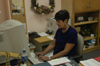 Staff Member of the Year Juanita Cotner works dilligently at her workstation where she provides desktop publishing services for the university. - Photo by Jonathan Blair