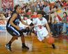 Jessica Graves, senior journalism major, dribbles past her Oklahoma City University opponent in the Semifinals of the NAIA National Tournament. The Lady Bulldogs advanced to the championship game with a win of 63-61. - Photo by Morris Abernathy
