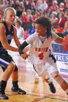 Jessica Graves, senior journalism major, dribbles around her Oklahoma City University opponent in the Semifinals of the NAIA National Tournament. The Lady Bulldogs advanced to the championship game with a win of 63-61. - Photo by Morris Abernathy