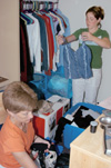 Kate Runyon of Evansville, Ind. and her mother unpack clothes while moving into her new dorm room at Union during FOCUS 2003. - Photo by Lindsay Stavish
