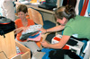 Kate Runyon of Evansville, Ind. and her mother unpack clothes while moving into her new dorm room at Union during FOCUS 2003. - Photo by Lindsay Stavish