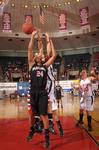 Kaitlin Dudley, senior physical education and health major, goes up for a rebound against her Azusa Pacific University opponent in the Championship game of the NAIA National Tournement. The Lady Bulldogs came out champions with a win of 73-65. - Photo by Morris Abernathy