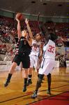 Kaitlin Dudley, senior physical education and health major, and Zeinab Chan, junior history major, play defense against their Azusa Pacific University opponent during the Championship game of the NAIA National Tournament. The Lady Bulldogs won the game 73-65. - Photo by Morris Abernathy