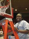 Lavanda Ross, sophomore, cuts a piece of the net after the Lady Bulldogs defeated Azusa Pacific University to win the NAIA National Tournament.  - Photo by Morris Abernathy