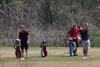 Jake Carroll tees off while Matt Kelley (far left) awaits his turn. - Photo by Steven Aldridge