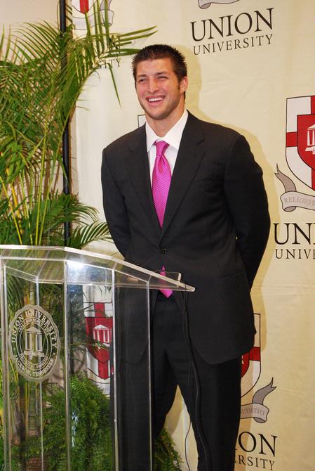 Tim Tebow answers questions at a press conference held before the Roy L. White Golf and Gala banquet.