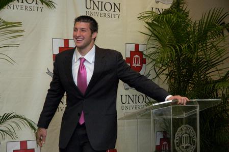 Tim Tebow answers questions at a press conference held before the Roy L. White Golf and Gala banquet.