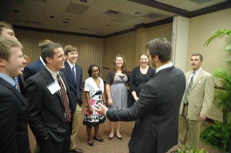 Tim Tebow, keynote speaker at the Roy L. White Legacy Golf and Gala, has a laugh with guests after the event.