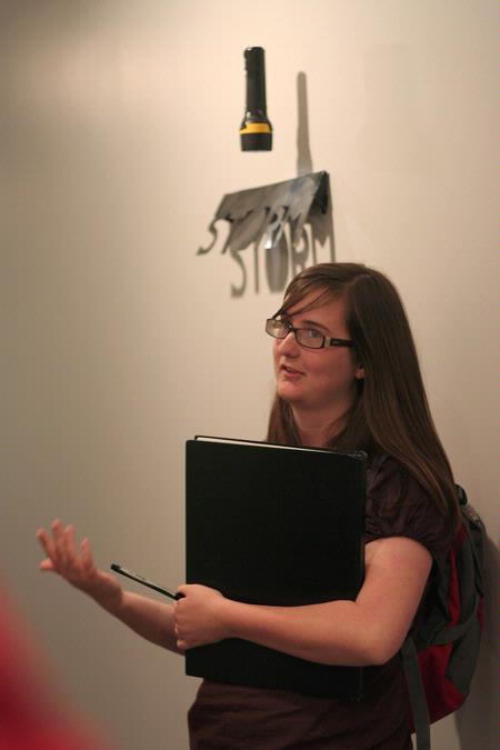 Kate Allen, sophomore art major, presents her point-of-display for the student film "The Storm" during Graphic Design II critique.