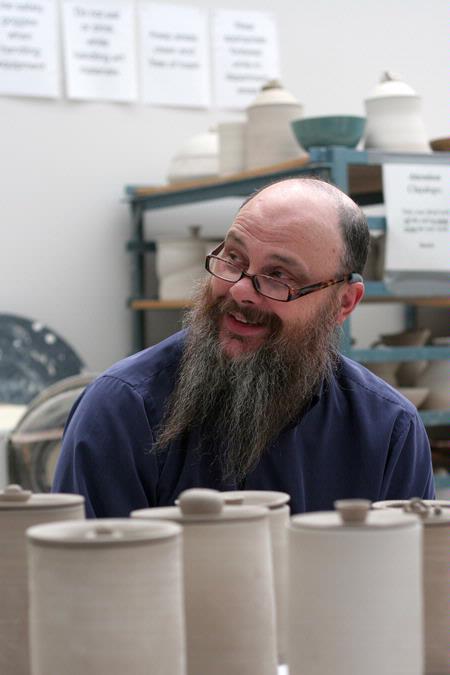 Lee Benson, professor of art and department chair, spends time in his students' studios. The art faculty invest a lot of their time in their students. 