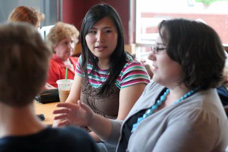 Shinae Giffin, sophomore art major, enjoys coffee with her graphic design classmates and professor Melinda Eckley after having class in Wal-Mart to research package design.