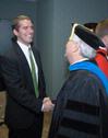 Jason Castles is congratulated by Dr. James Huggins after being named Staff Member of the Year at the Awards Day chapel. - Photo by Morris Abernathy