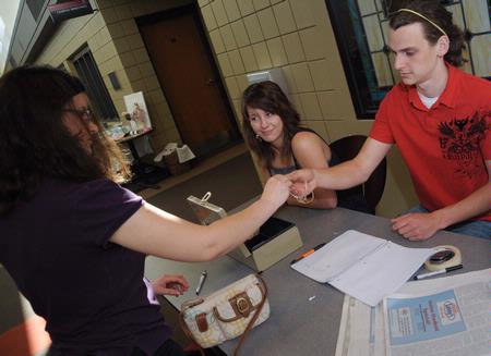 Maggie Ledbetter, sophomore physical education and health major, and Zac Benson, junior art major, work at the Mother's Day Pottery and Art Sale. 