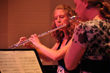 Robyn Kyzar, junior nursing major, and Kayleigh Hines, junior music major, play the flute and alto flute at a music recital in Hartley Hall