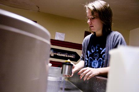 Emma Robertson, junior music education major, develops her photography project in the Photo House. 