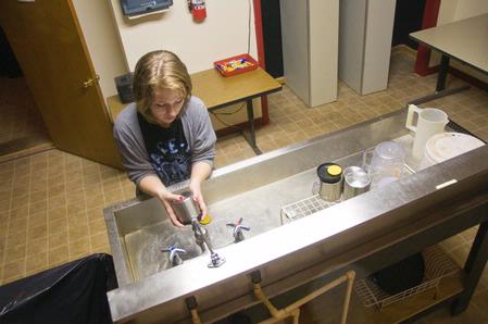 Emma Robertson, junior music education major, develops photos in the Photo House. Students at Union have the opportunity to learn how to process and print their own film in photography classes. 