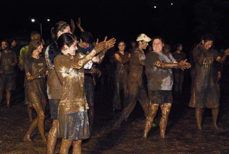 Students do the cha-cha in the mud at Midnight Mudness sponsored by Young Alums.