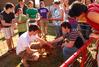 Students gather on the lawn of the Heritage complex to see a visiting baby kangaroo. - Photo by Abigail Harris