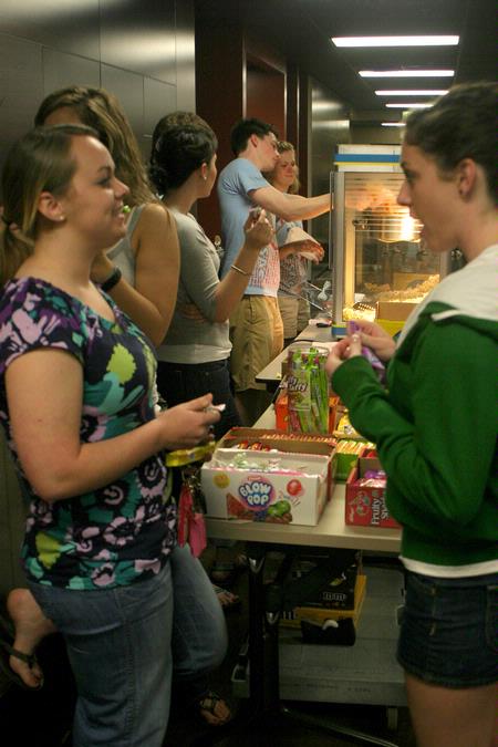 Students enjoy the free snack, drink and bag of popcorn provided by the Student Activities Council during the Movie in the Bowld Student Commons.