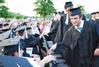 Josh Allen, graduating Christian studies major, high-fives classmates as he waits in the graduation line at the Spring 2010 Graduation Ceremony. - Photo by Abigail Harris