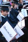 Graduating seniors check out their diplomas after receiving them at the spring 2010 commencement ceremony. - Photo by Abigail Harris