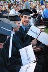 Hilmar Jonathan Skagfield, graduating philosophy major, excitedly displays the cover where his diploma will go will he completes his July classes.  - Photo by Abigail Harris