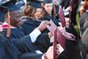 Masters graduates enjoy looking at their diplomas after receiving them at the spring 2010 commencement ceremony. - Photo by Abigail Harris