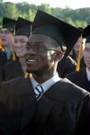 Computer science graduate Toyin Adedokun listens to the speaker at the Spring 2010 commencement ceremony. - Photo by Beth Spain