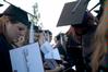 Graduating art major, Katy Pope, reviews her diploma after receiving it during the Spring 2010 graduation ceremony. - Photo by Beth Spain