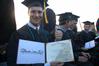 Mathematics graduate, Peter Boedeker, proudly displays his diploma after receiving it during the Spring 2010 commencement ceremony.  - Photo by Beth Spain