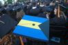 A few students decoratively represent national flags on their graduation caps at the spring 2010 graduation ceremony. - Photo by Beth Spain