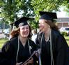 Graduating seniors Margaret Broersma, theatre/speech major, and Jill Brown, French major, laugh in the line before the spring 2010 graduation ceremony. 
 - Photo by Ebbie Davis